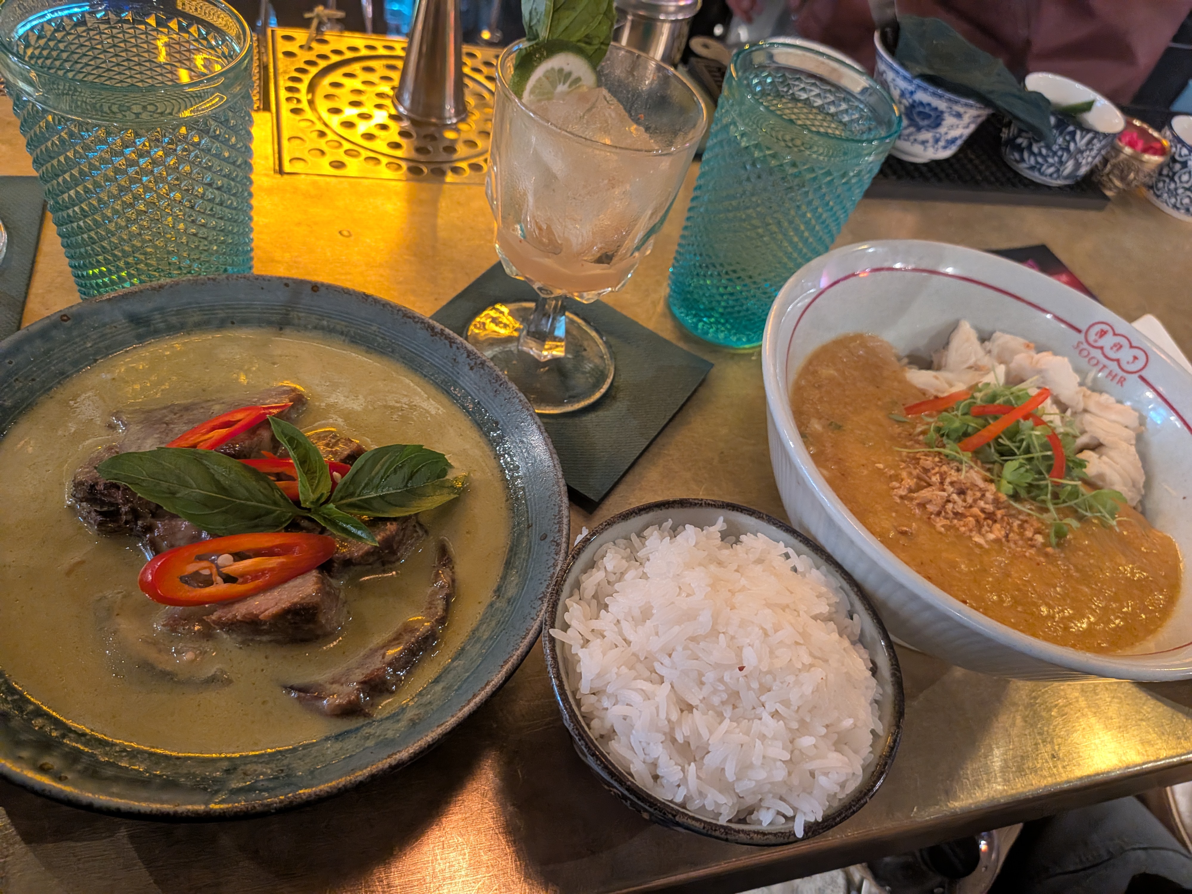 Full spread at Soothr Thai restaurant including green curry and crab noodles